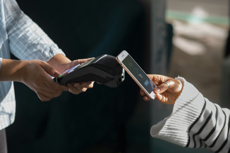 person-paying-with-nfc-technology-restaurant.jpg